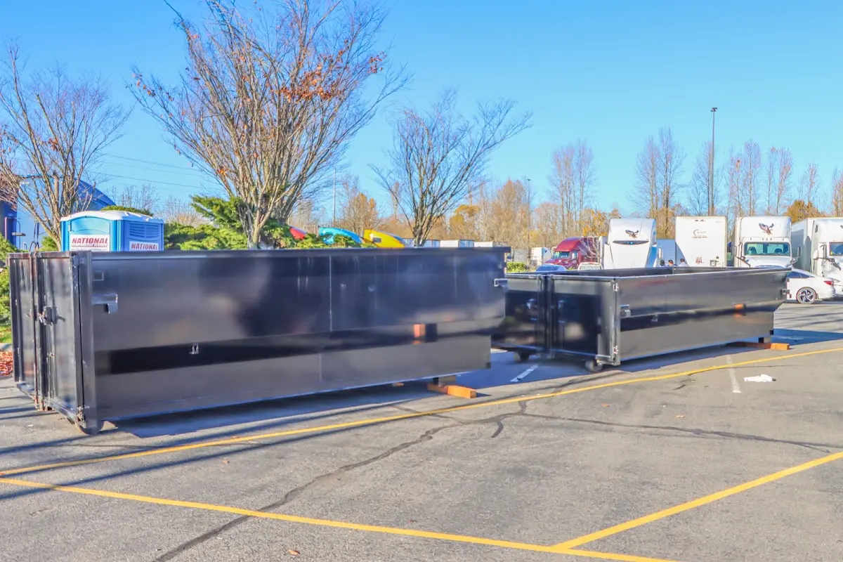 Professional dumpster rental service with roll-off container on residential driveway in Bremerton